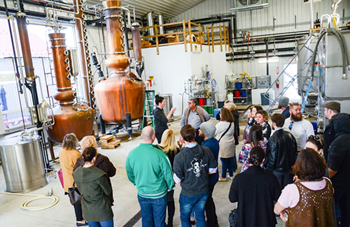 Tour group in front of copper stills at Nauti Spirits