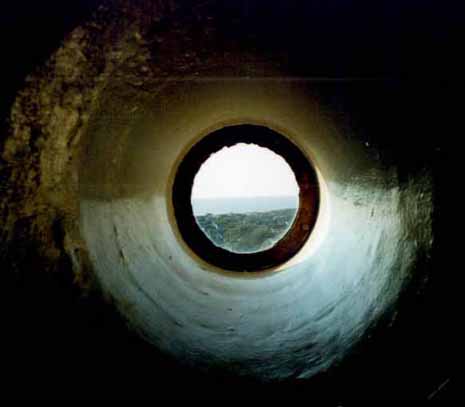 LighthousePorthole One of several portholes near the top of the tower that look out over Cape May Point, Lake Lily and the beaches.