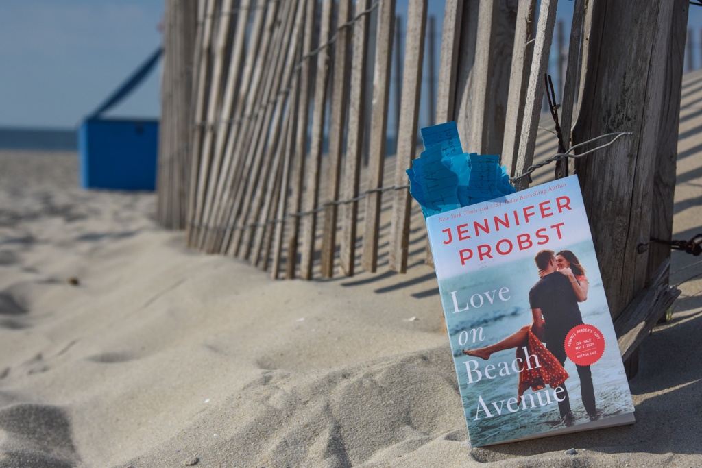 Photograph of the novel Love on Beach Avenue taken on the sand