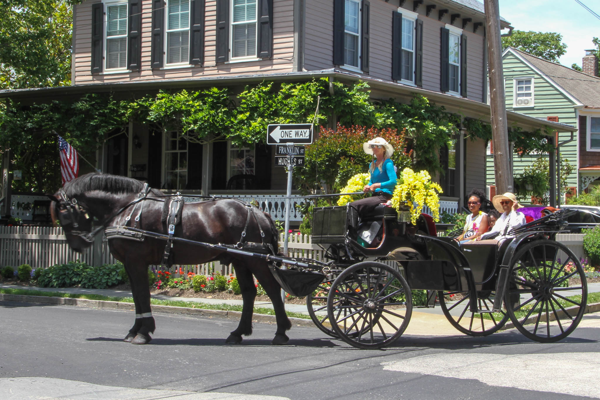 A family turning on Hughes Street while on the Cape May Carriage.