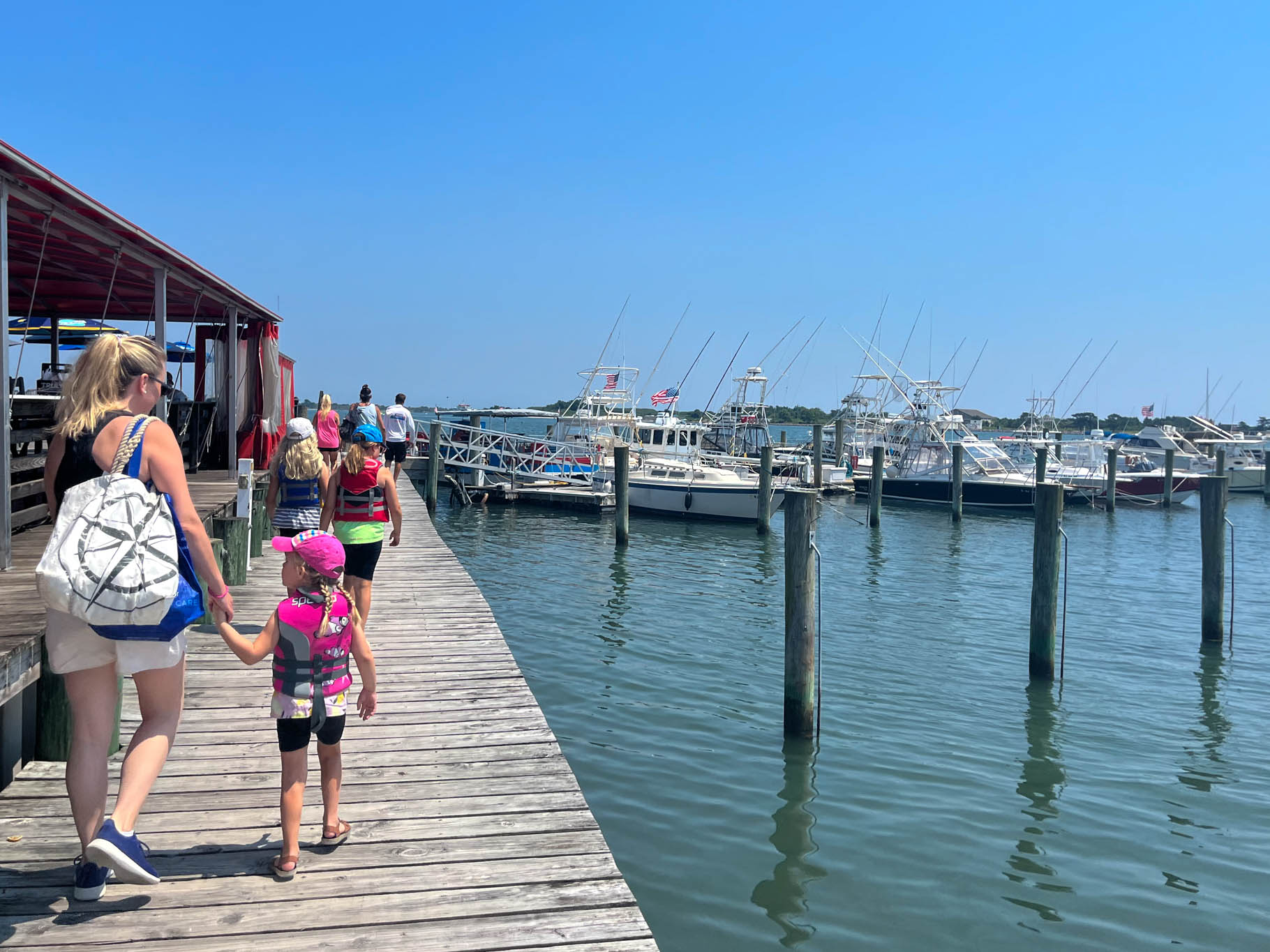 Everyone walking on the dock to the 
 Cape May Cycle Cruises boat.