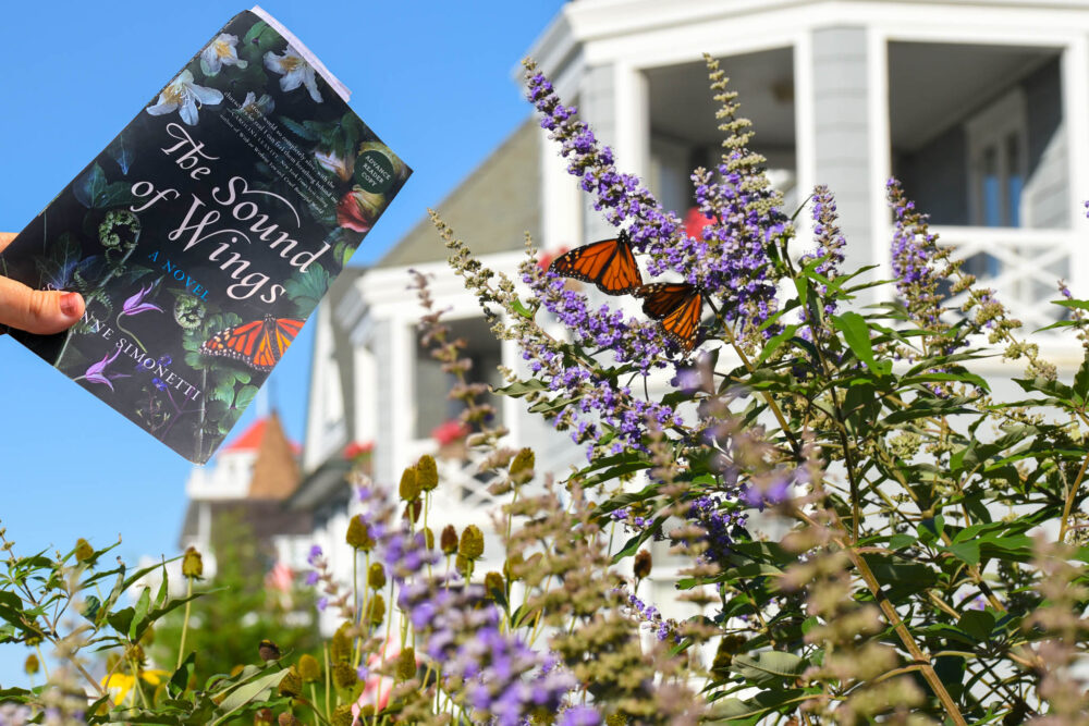 The Sound Of Wings book over a butterfly garden