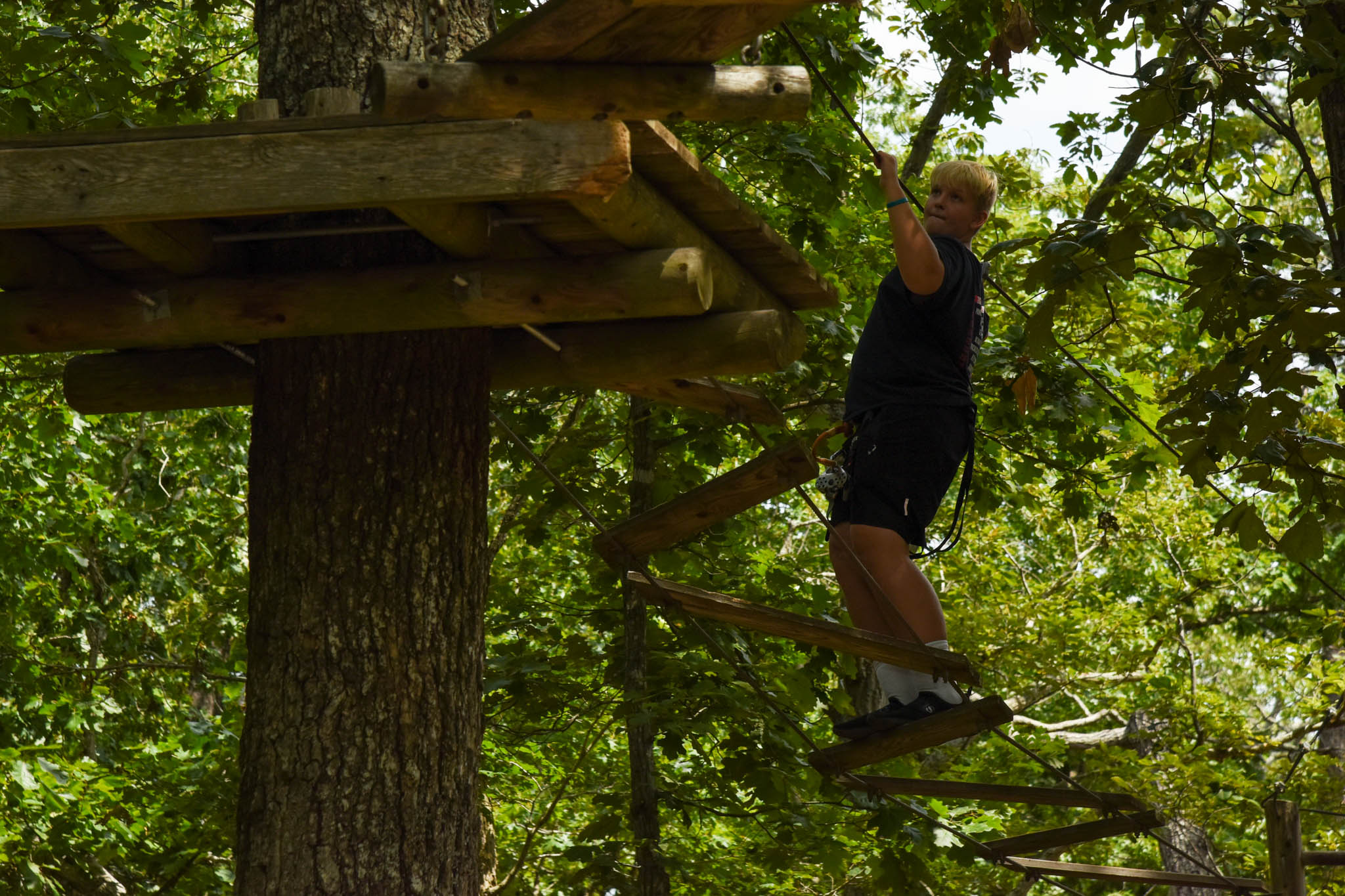 Gabe is navigating his way up high at Tree to Tree.