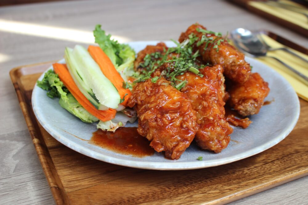 Hot wings on a plate with carrots and celery