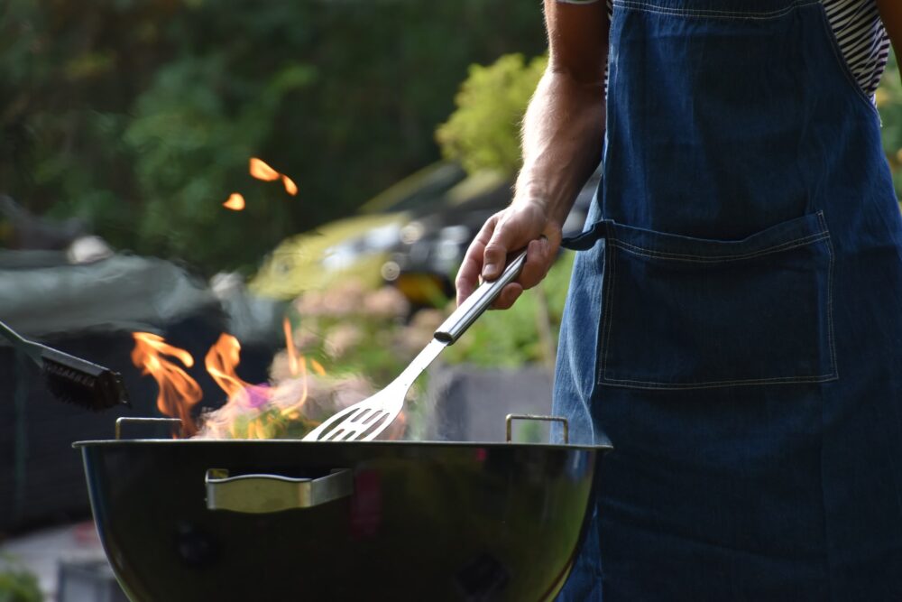 A person grilling over an open flame