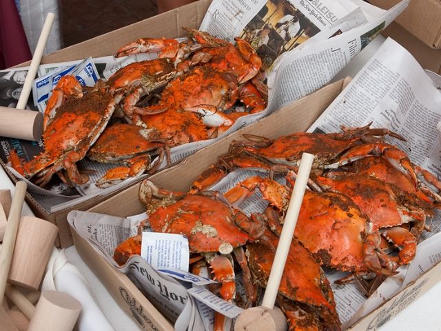 Boxes of steamed crabs and wooden hammers on newspapers