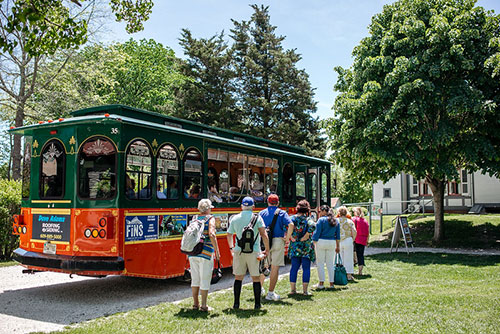 Group of people boaring a MAC trolley