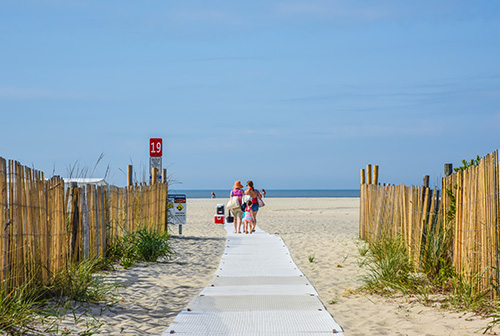 A family walking onto the beach