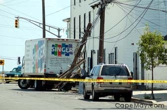 A truck takes down powerlines at the corner of Decatur and Beach