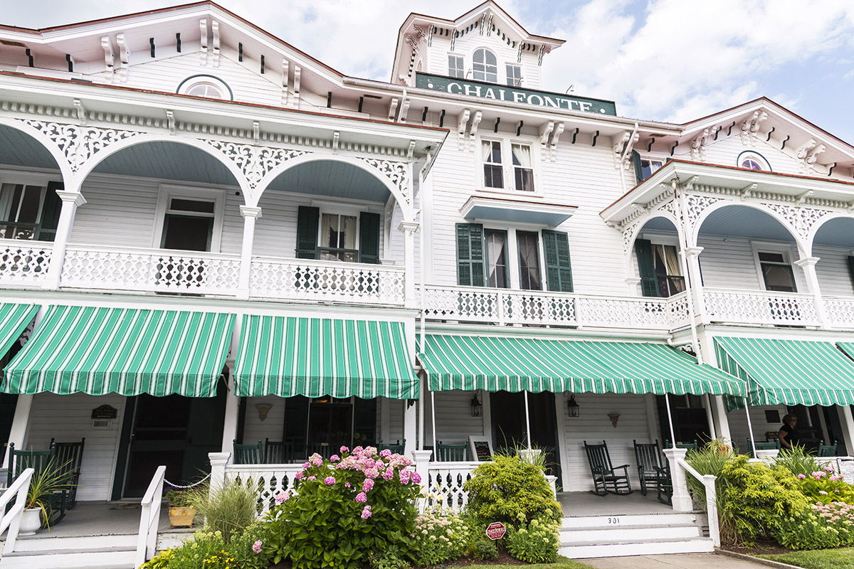 The Chalfonte, a victorian styled white building with green shudders, with a blue sky