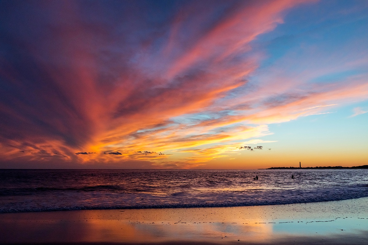 Colorful clouds in the sky and colors reflected in the shoreline