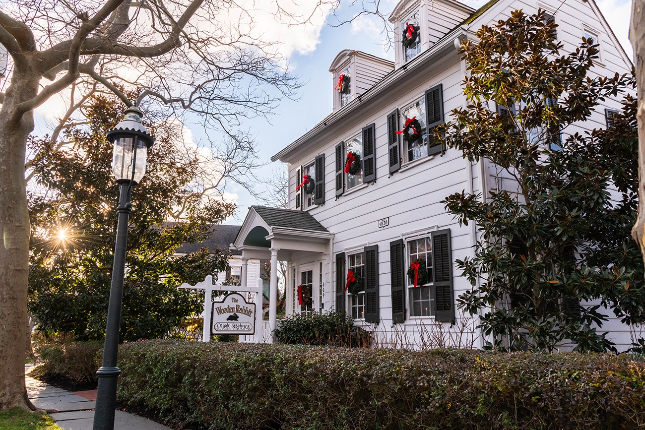 White Victorian house with Christmas wreaths on the windows