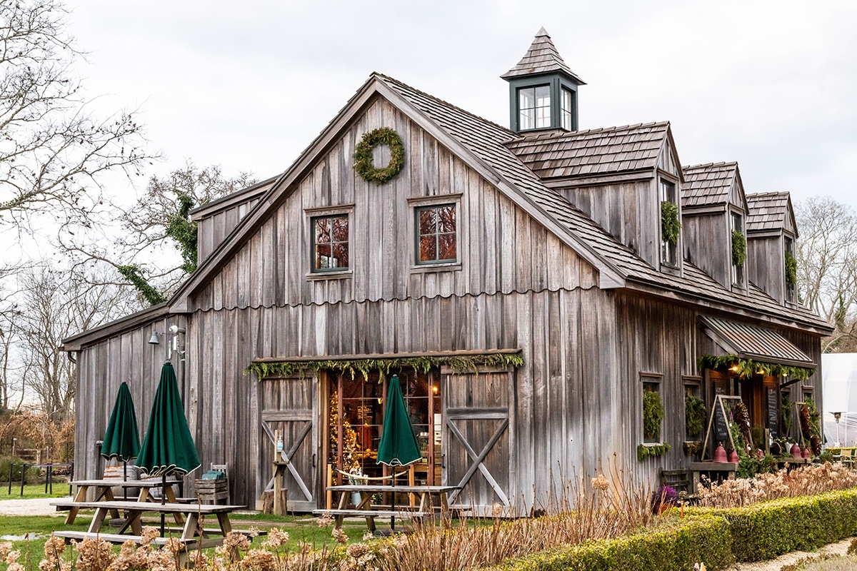 Holiday evergreen decorations at Beach Plum Farm with a Christmas tree in the window