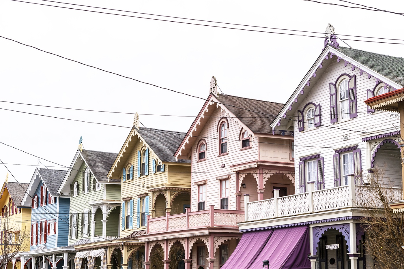 The tops of colorful Victorian houses in a row.