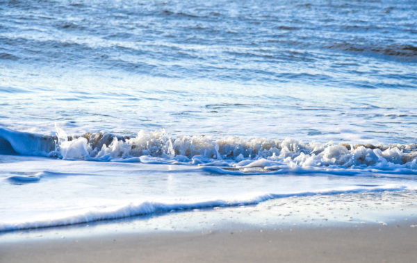 watching small waves at the waters edge.