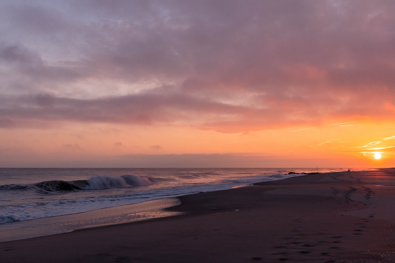 Pink clouds in the sky at sunset on the beach