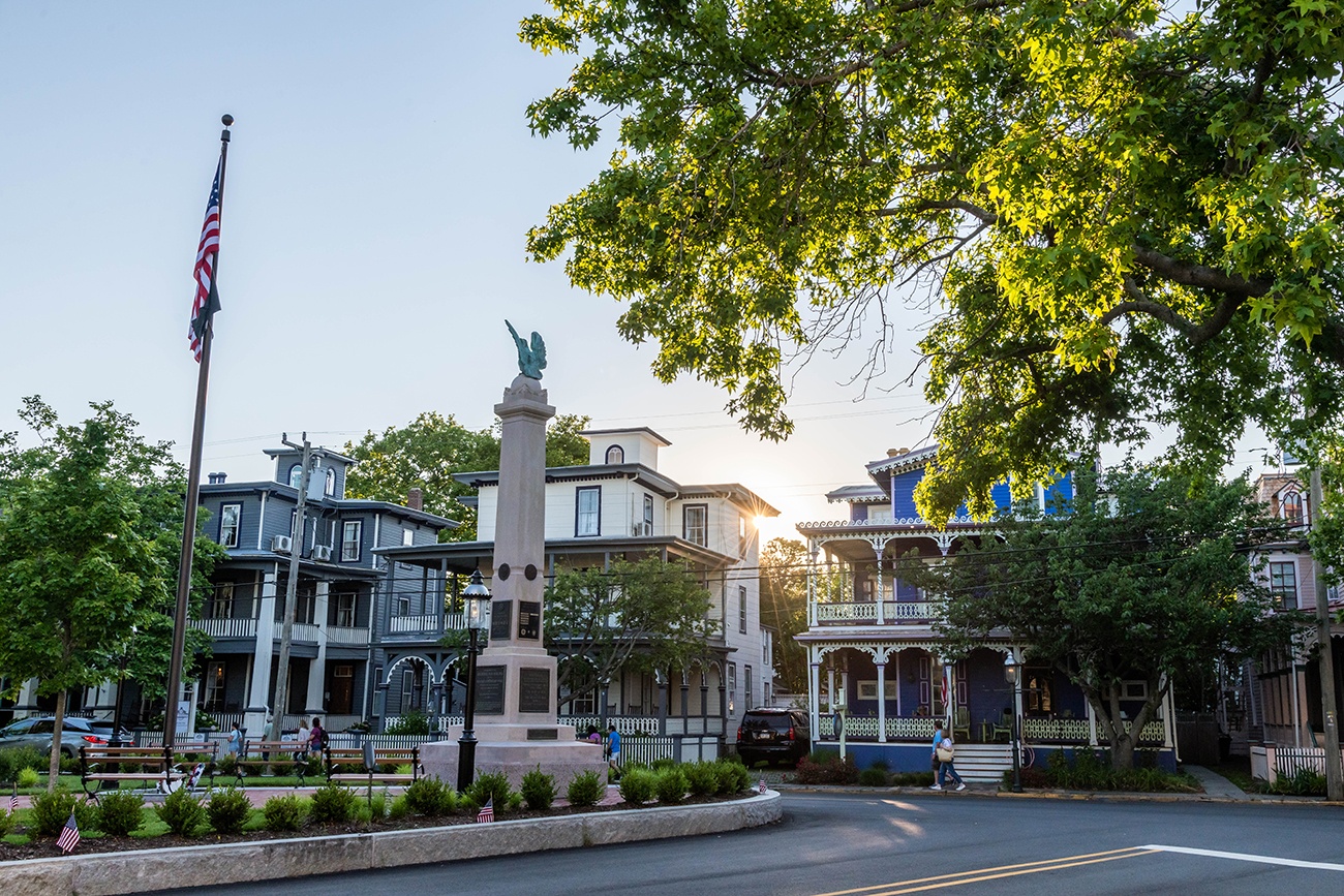 The sun setting behind victorian style houses 