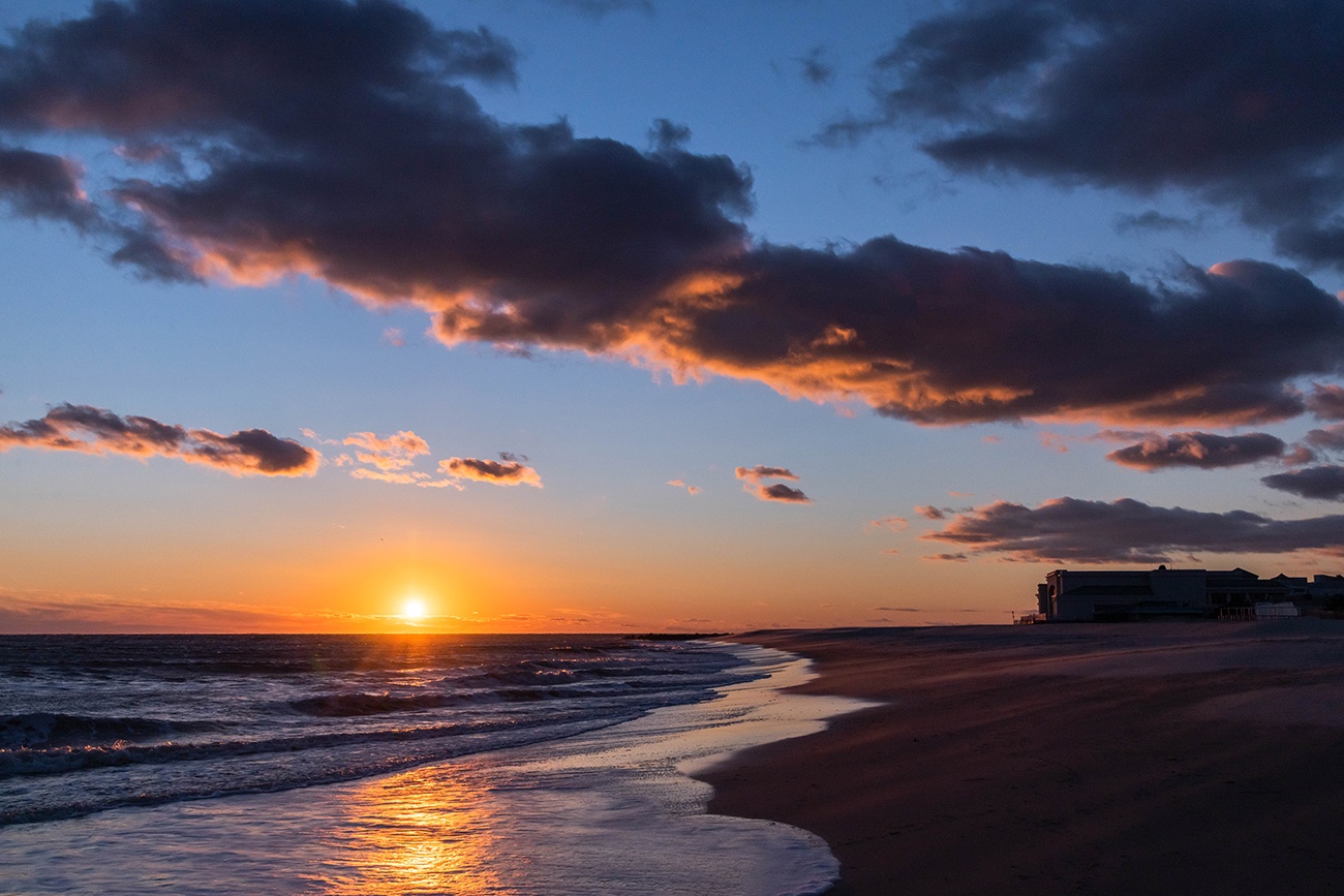 Puffy clouds in the sky at sunset at the beach