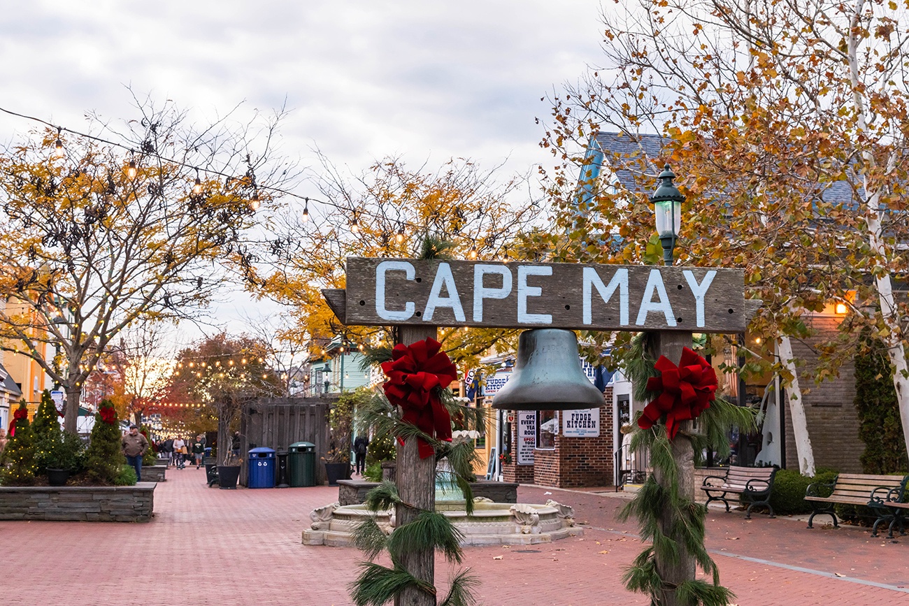 The Cape May sign at the Washington Street Mall with red bows and green garland