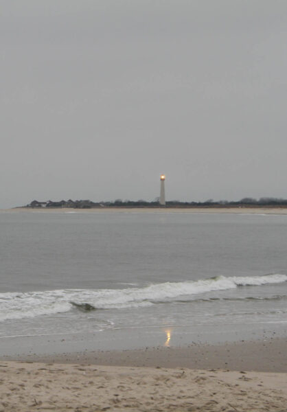 Stormy day at The Cove the Cape May Lighthouse shinning.