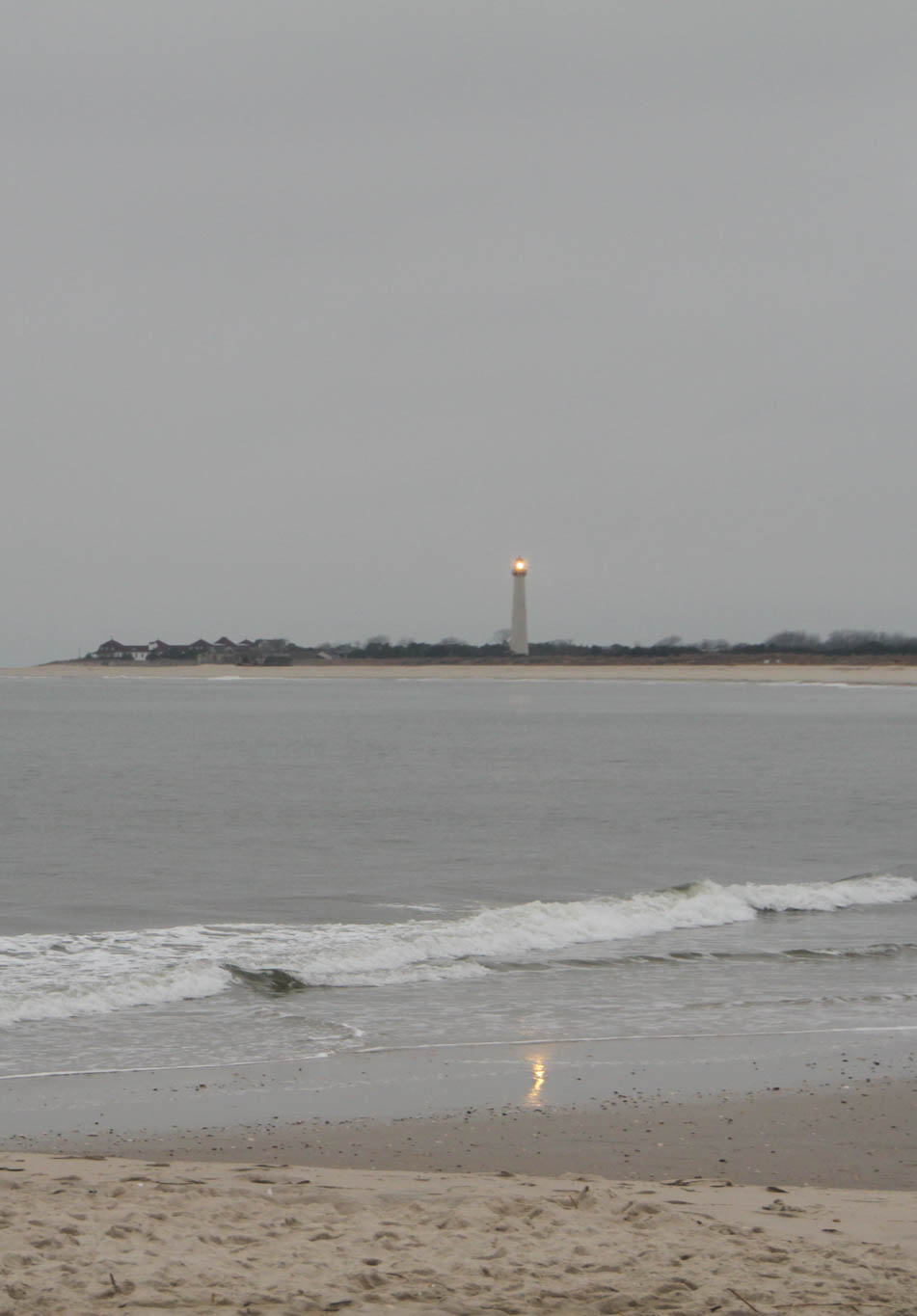 Stormy day at The Cove the Cape May Lighthouse shinning. 