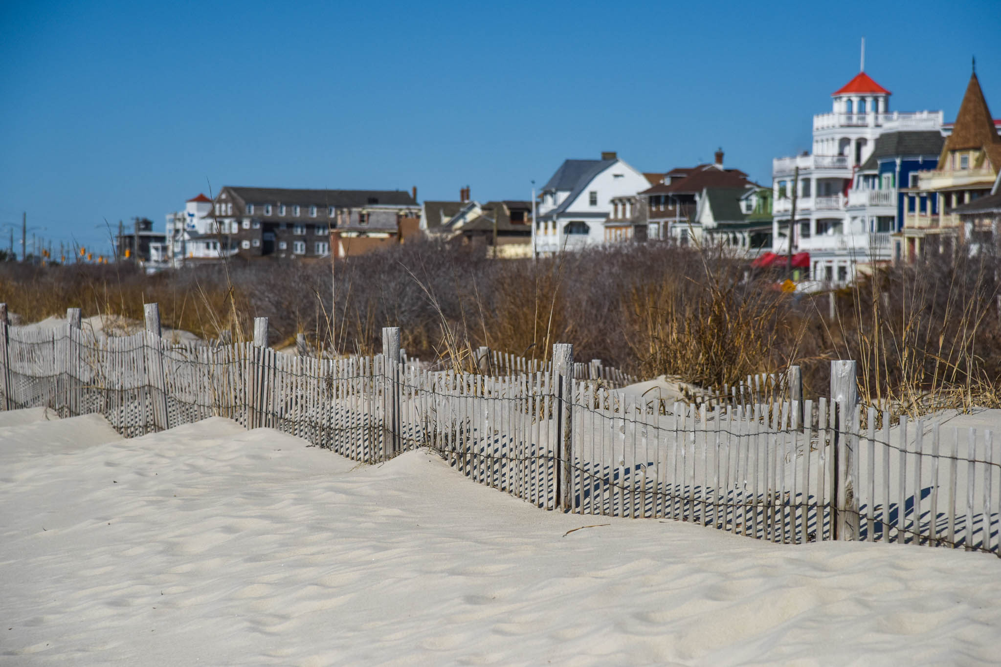 Sandy Fence Line along the dunes with houses on Beach Ave
