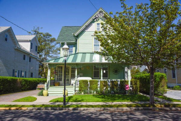 a Green house with green grass and leaves on Broadway.