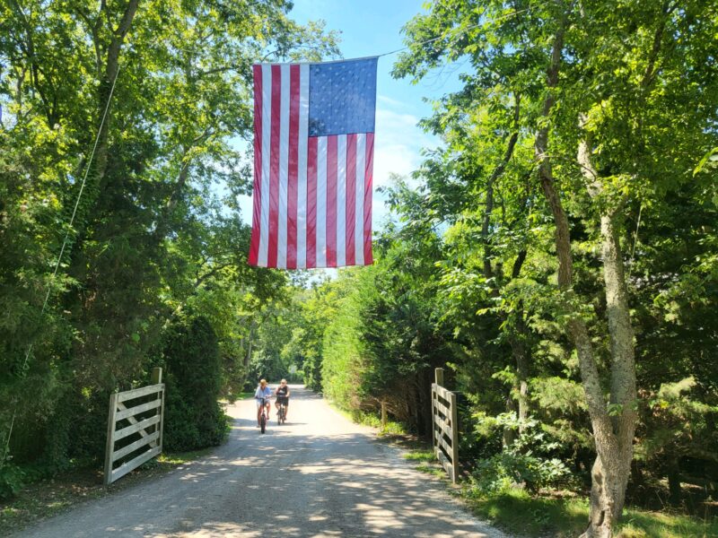 Two people riding on a bike path