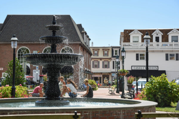 kids sitting along the Fountain with a Breeze