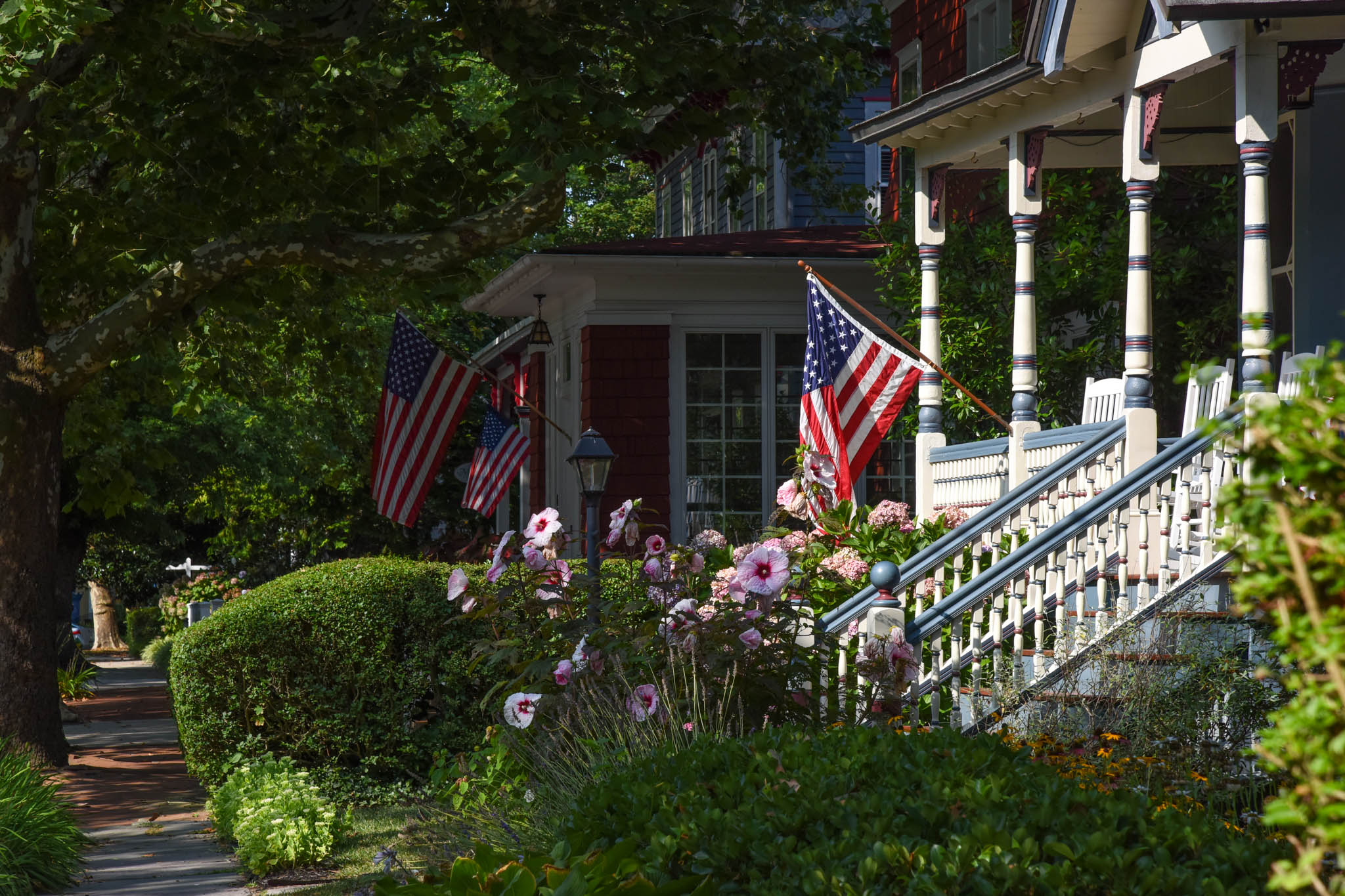 a shady path with sunlight on a front porch on Hughes Street