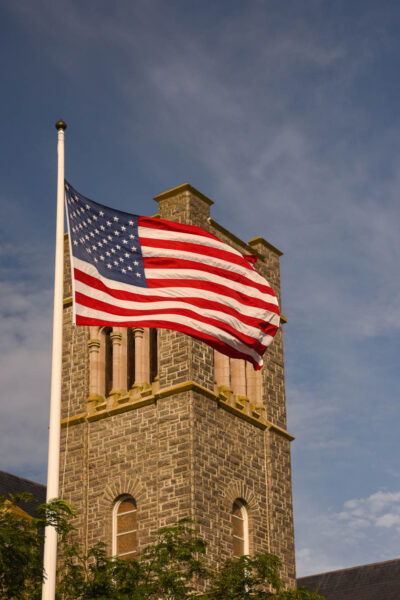 Standing on Ocean Street looking up at the American Flag and Our Ladt Start of the Sea in the background