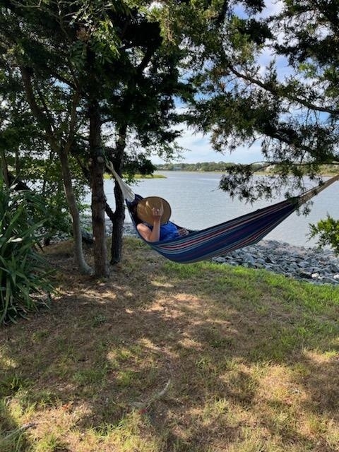 Person napping in a hammock next to the Cape May Canal