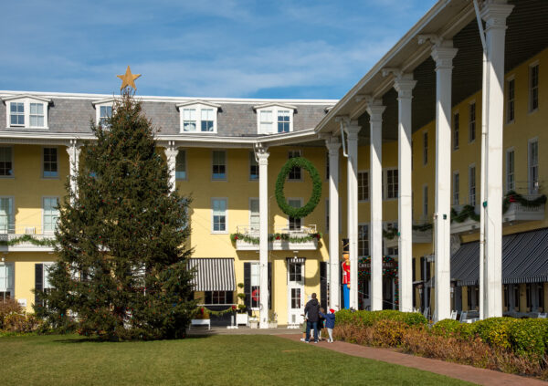 A family walking in to Congress Hall from the back. Looking at the Christmas tree.