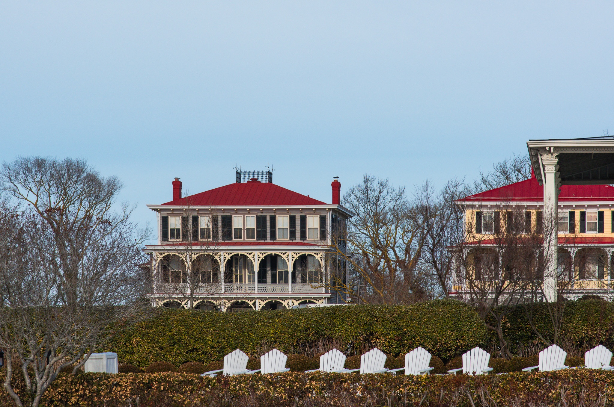 The Congress Hall chairs behind the hedge, and homes behind them 