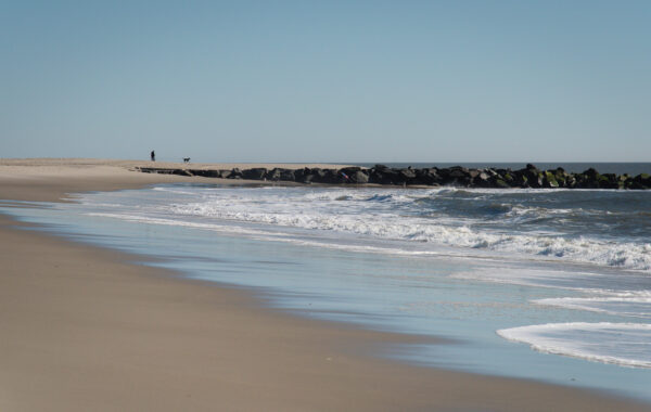 Walking the Puppy in the distances as the wave crash onto the beach