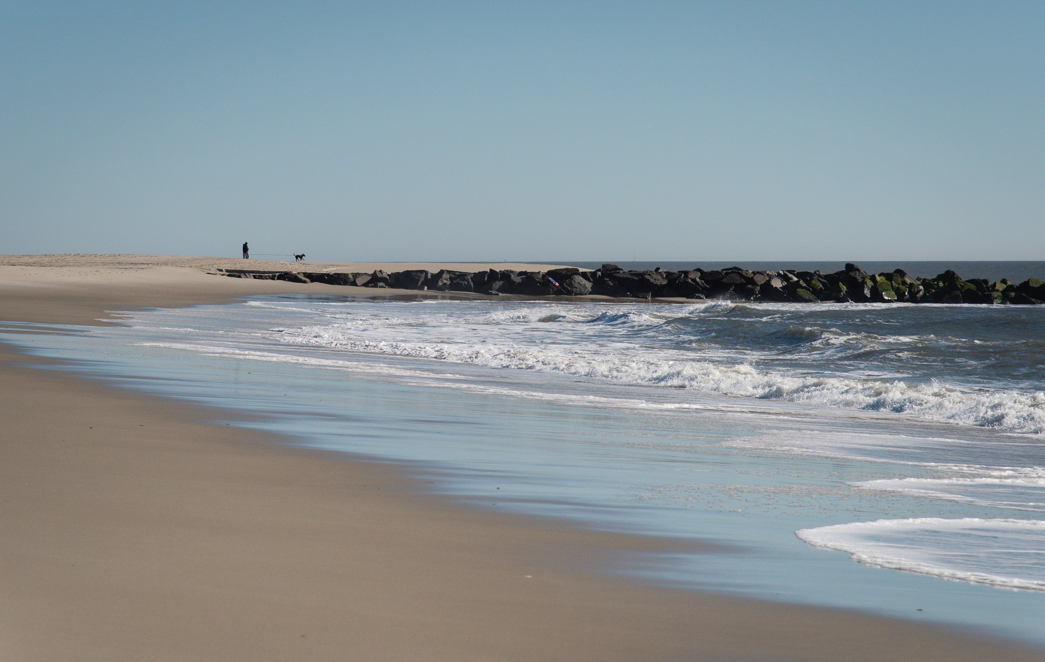 Walking the Puppy in the distances as the wave crash onto the beach