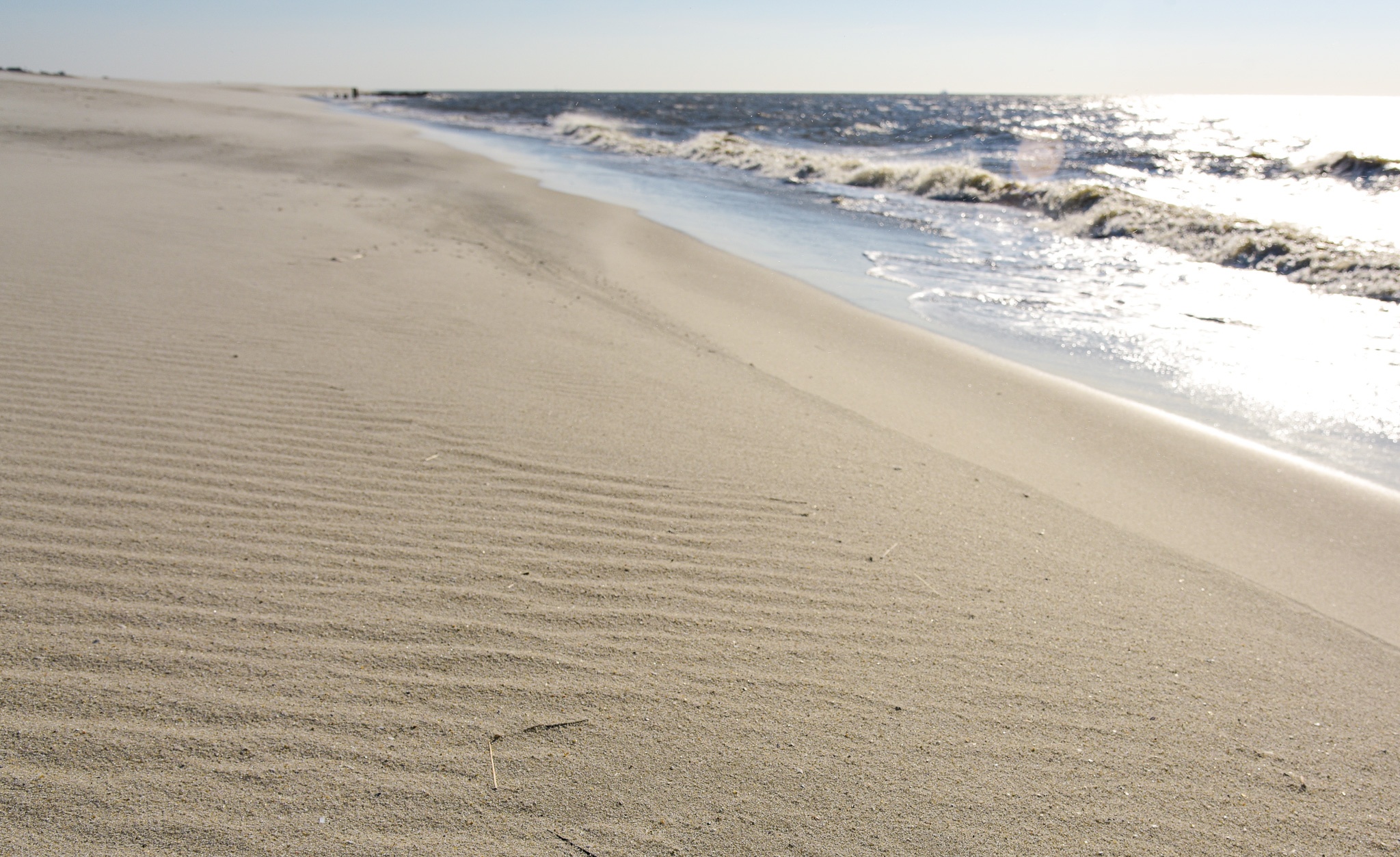 on the beach looking at Ripples in the Sand along the ocean