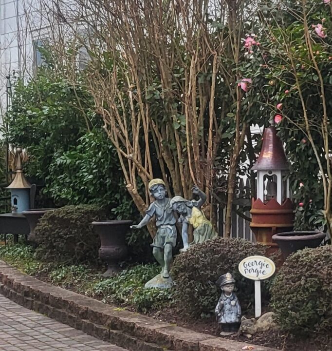 Child garden statues and a sign reading 'Georgie Porgie'