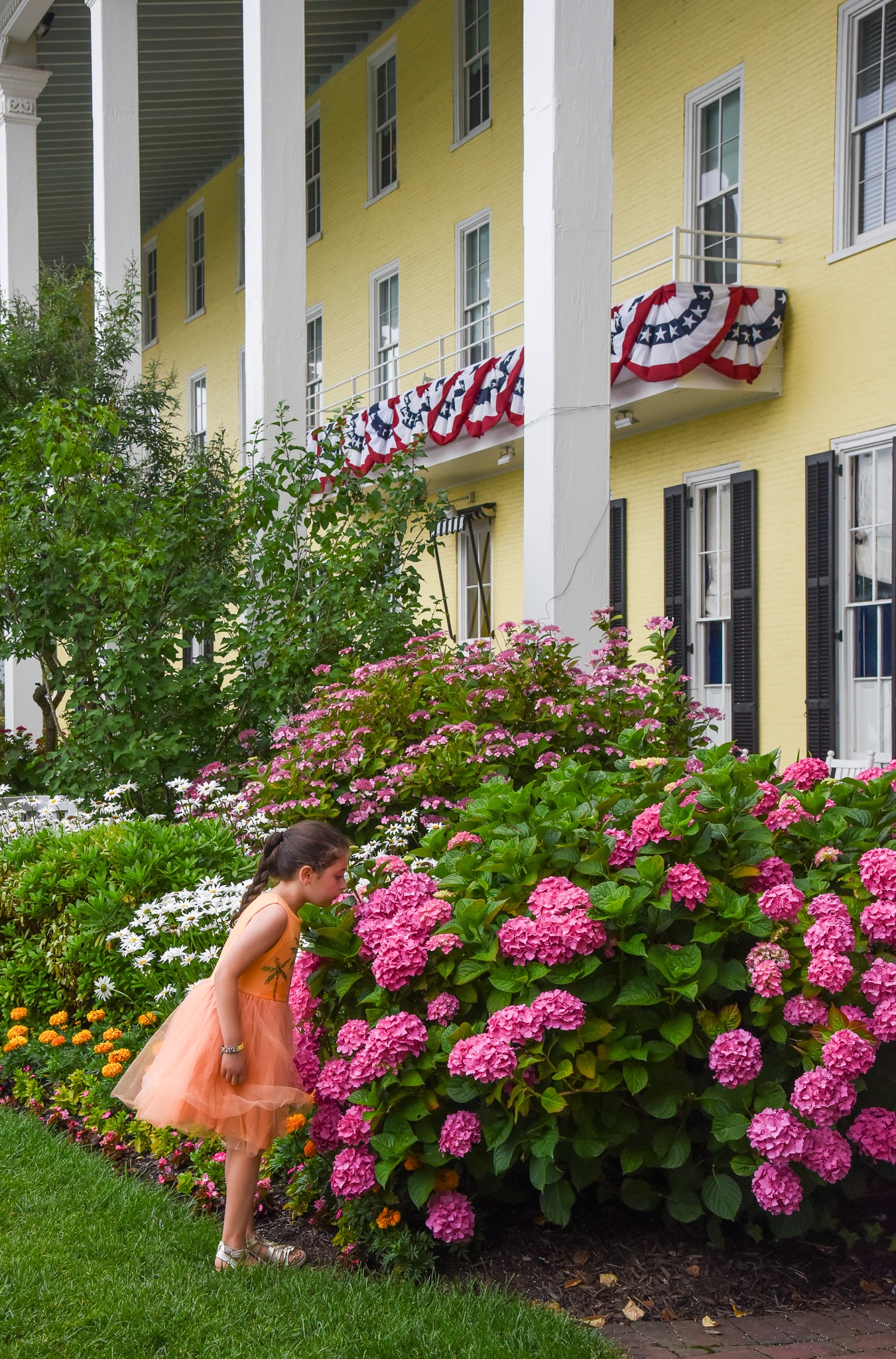 A young girl smelling the flowers at Congress Hall