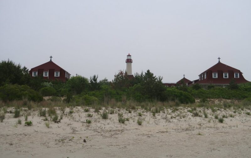 Saint Mary's by the Sea and the lighthouse behind sand dunes on the Cape May Point beach