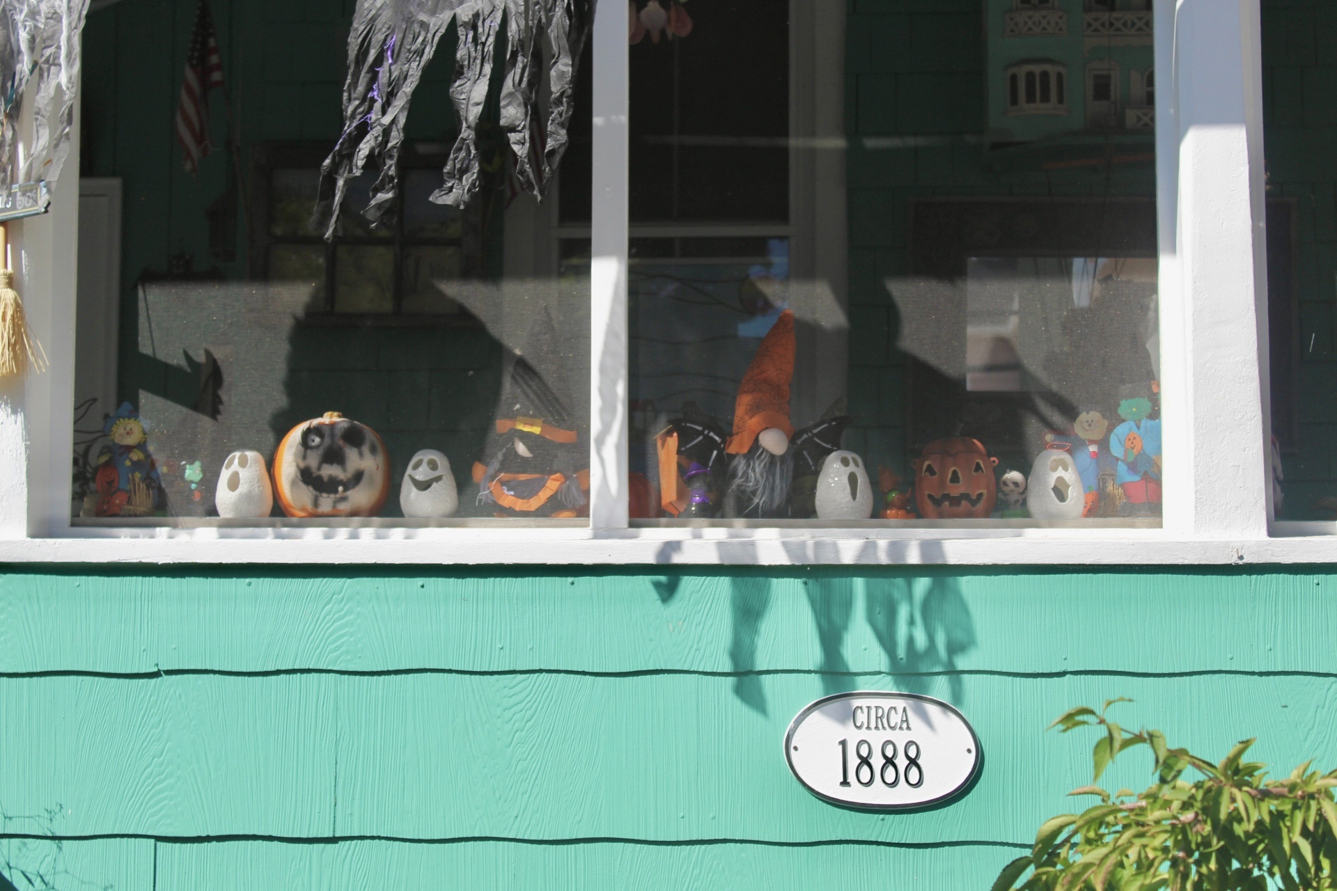 Halloween decorations in the window of a Cape May Victorian home