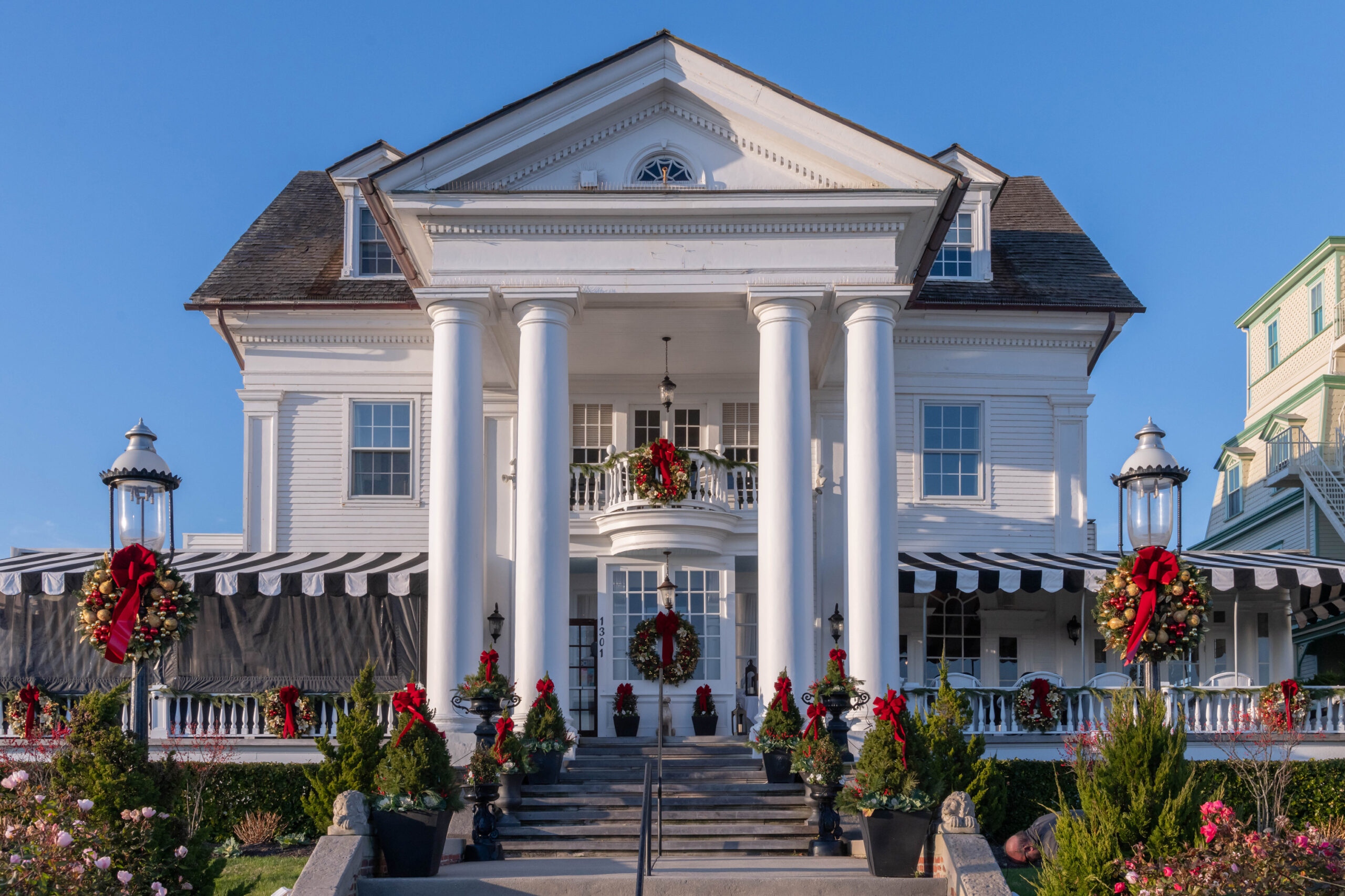 Green wreaths and trees with red bows decorated on Peter Shields Inn