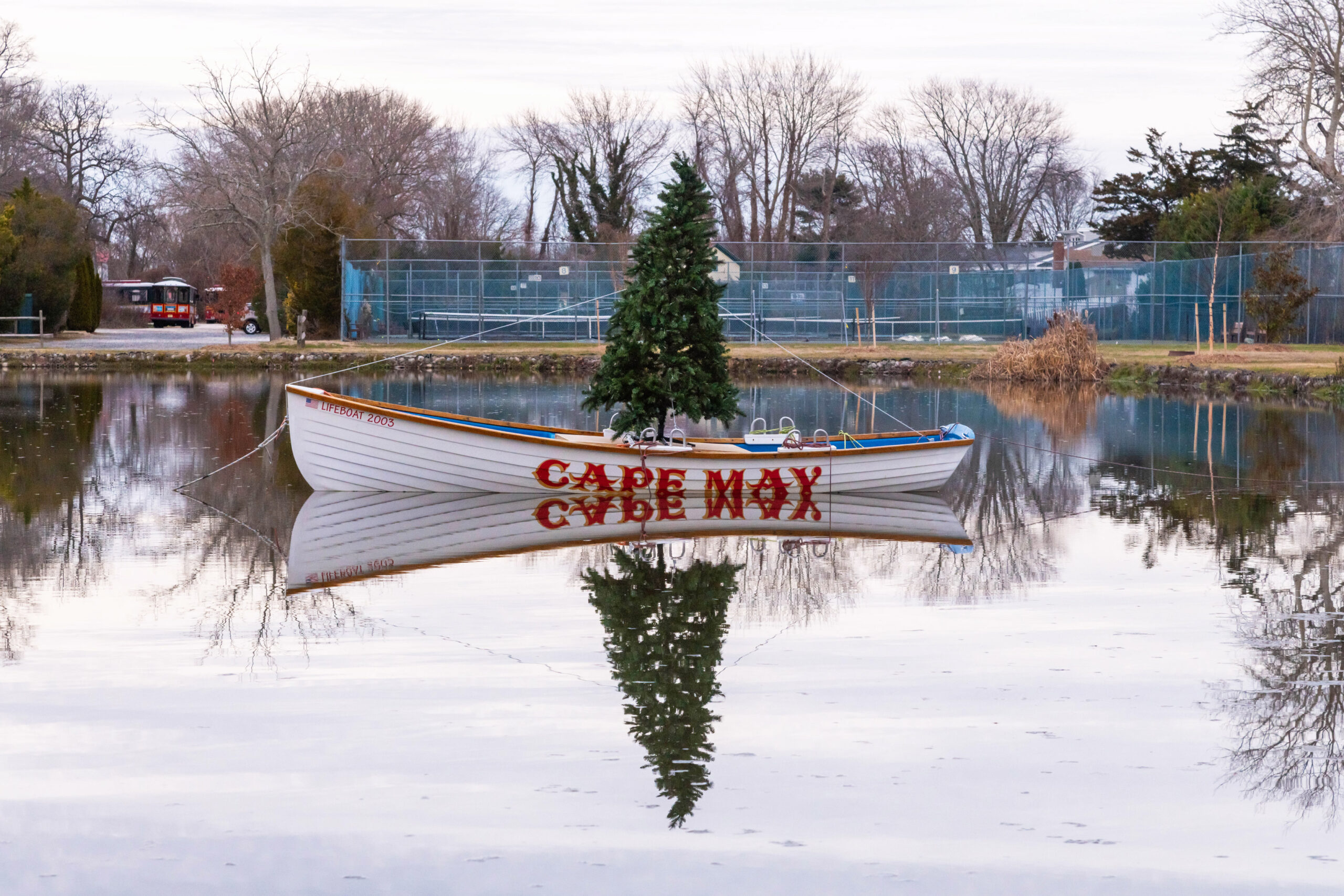 A Christmas tree in a Cape May lifeguard boat in the pond at the Kiwanis Community Park on a cloud day