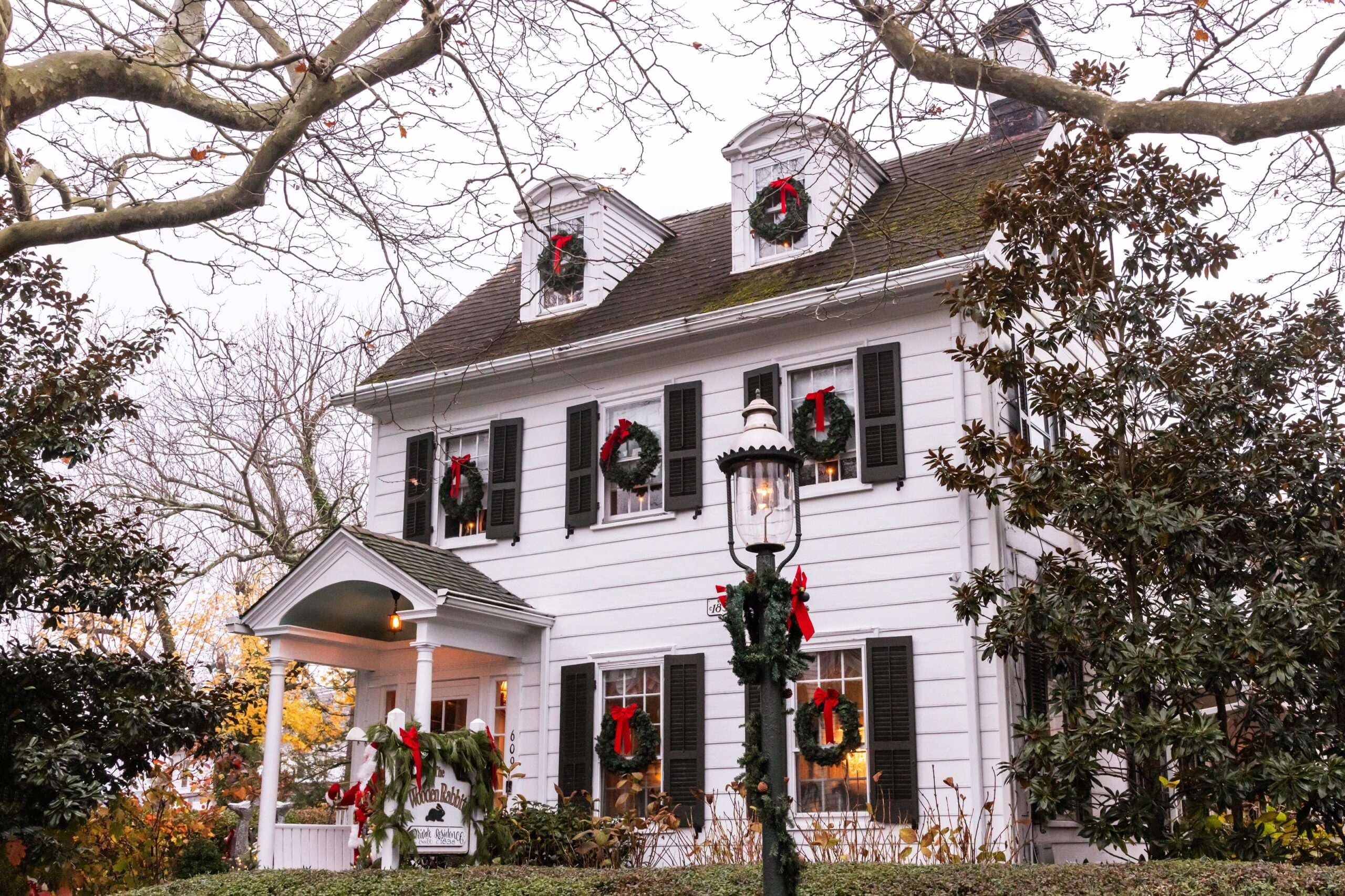 Christmas wreaths decorated on the Wooden Rabbit, a white Victorian style home.