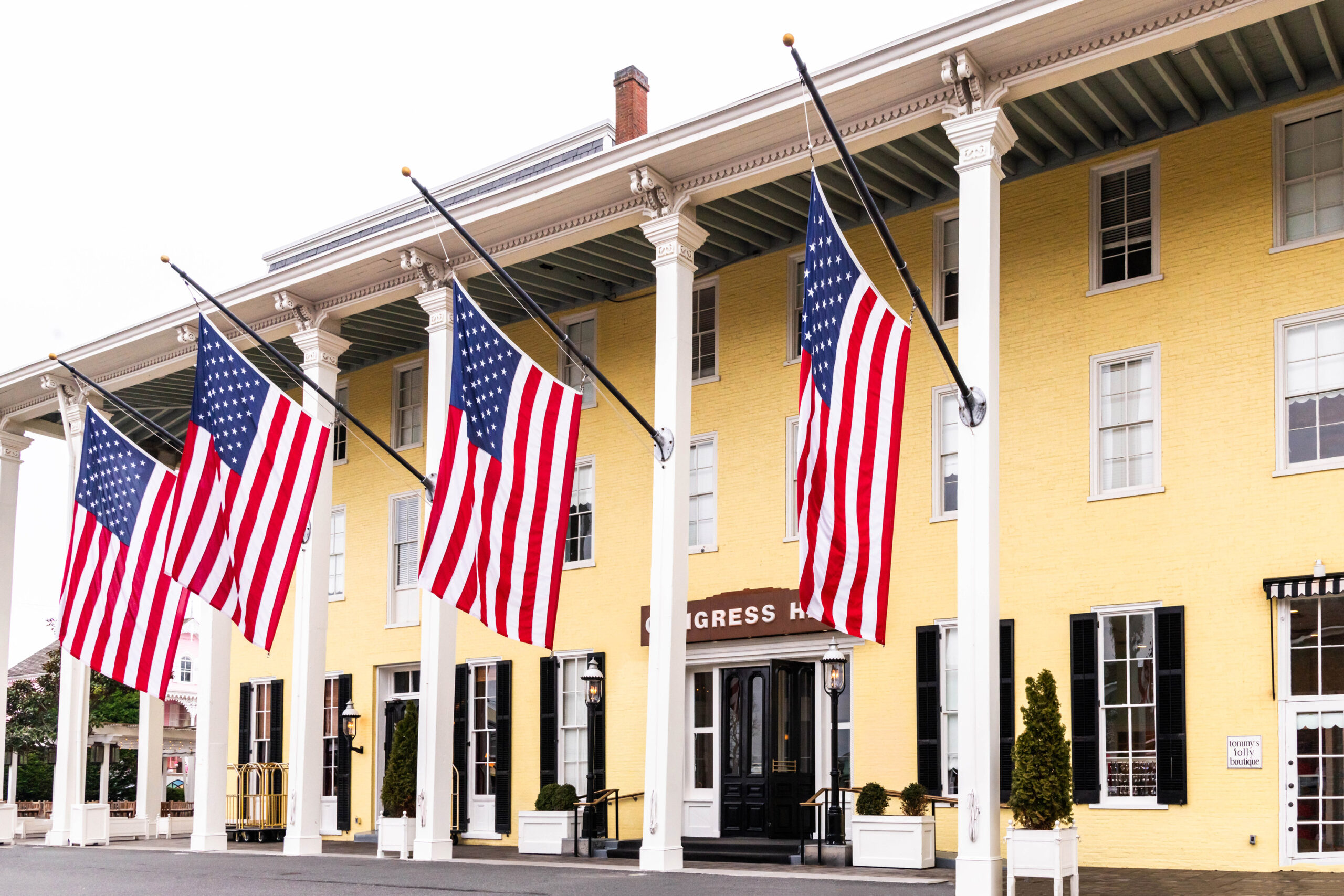 Four big American Flags hanging on Congress Hall on a cloudy day