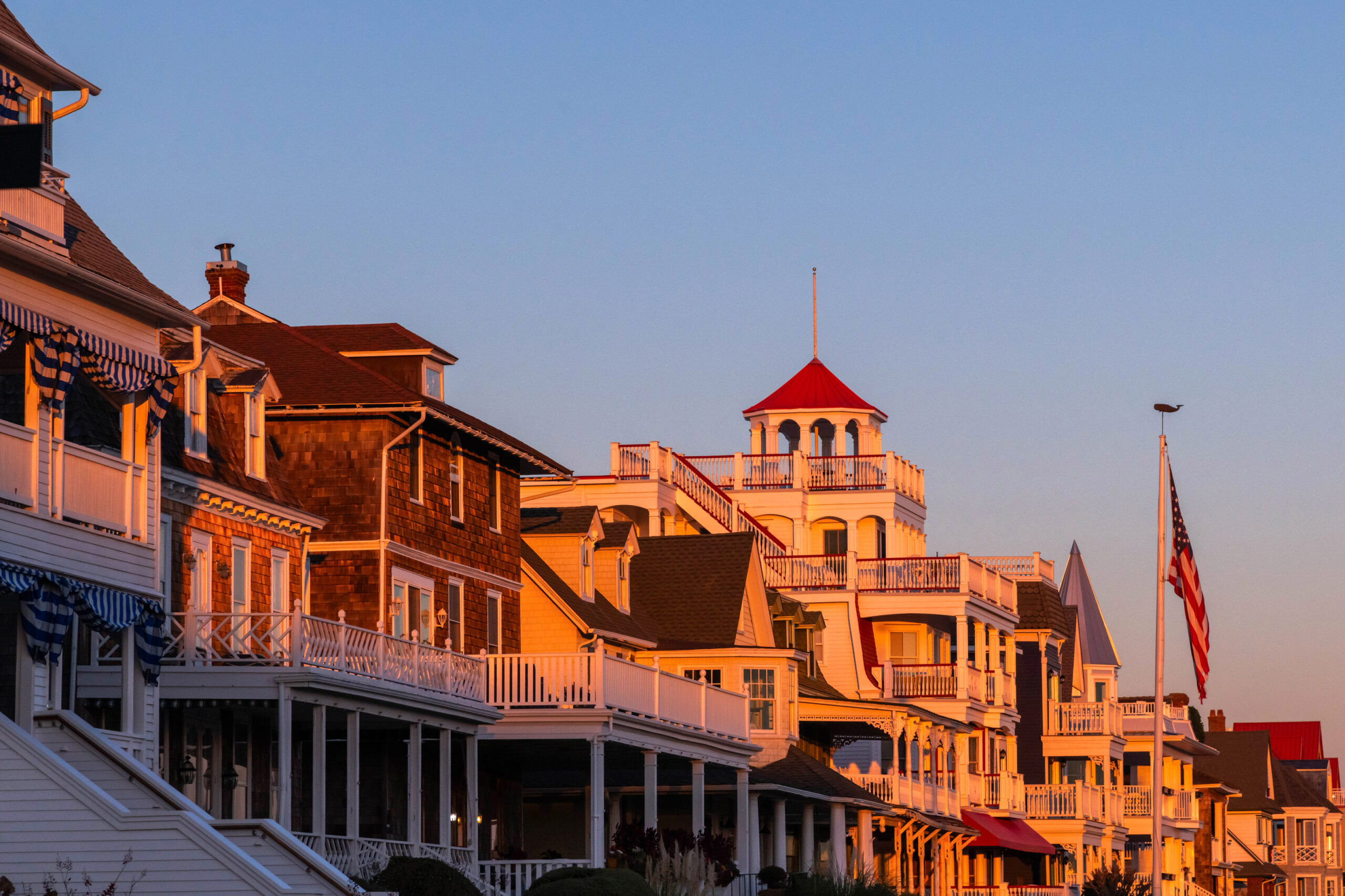 The setting sun shining on the houses on Beach Avenue with a clear sky