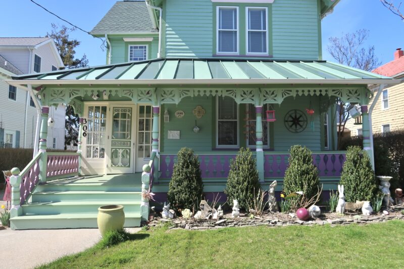 Front porch of a home at 306 S Broadway; green and purple house. 