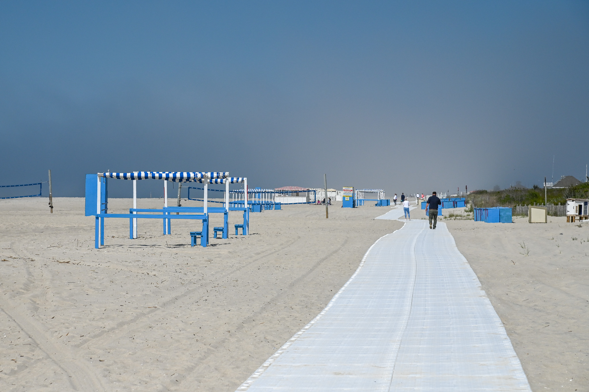 People walking along the new path along the beach