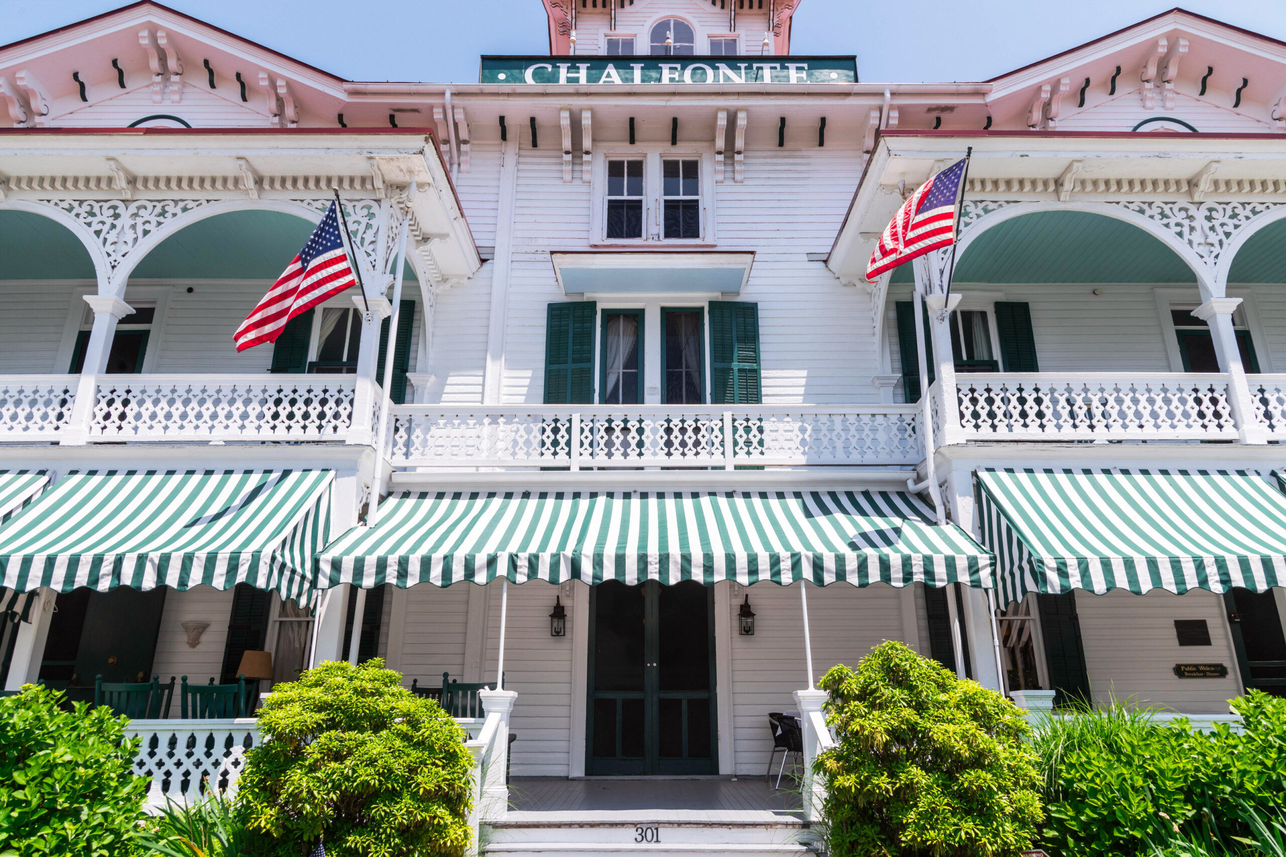 The front of the Chalfont on a bright sunny day. Two American Flags are hung on the building and are blowing in the breeze.