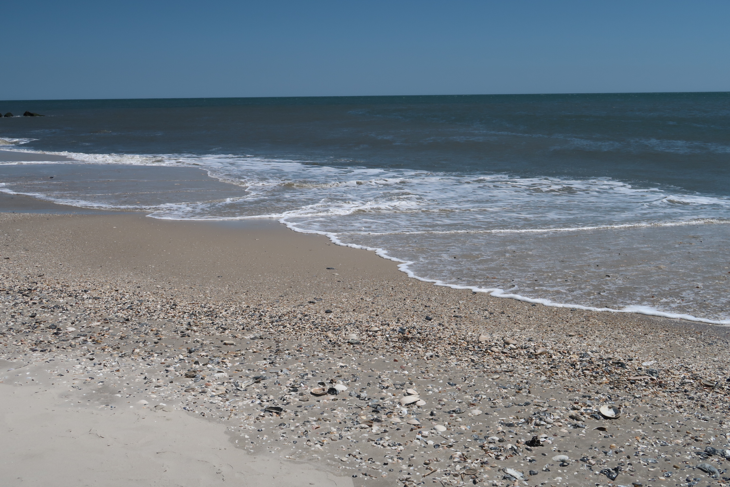 Waves wash up on sand on Steger Beach